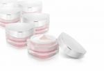 Many Pink Triangle Cosmetic Jar On White Background Stock Photo