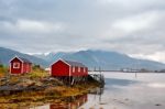 Norwegian Hut Rorbu On Bay Coast. Nordic Cloudy Summer Day Stock Photo