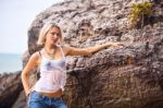 Beautiful Young Blonde Woman Posing Outdoor At The Rocky Sea Sho Stock Photo