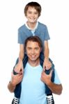 Adorable Young Son Enjoying Piggyback Ride Stock Photo