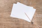 Blank Paper With Pencil On Wood Table Stock Photo