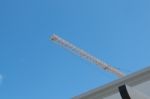 Yellow High Long Crane Arrow At Construction Site With Clear Light Blue Sky Day Stock Photo