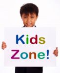 Small Boy With Kids Zone Board Stock Photo