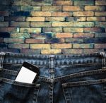 Blue Jeans With Cell Phone In A Pocket Background Stock Photo