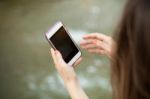 Young  Woman Taking A Photo With Her Phone Stock Photo