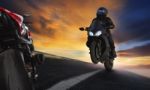 Young Man Riding Motorcycle On Asphalt Highways Road With Profes Stock Photo