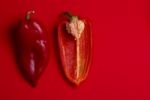 whole and halved Red Peppers Stock Photo