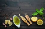 The Ingredients For Green Pesto Sauce On Dark Wooden Background Stock Photo