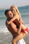 Man Carrying Woman At Beach Stock Photo