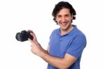 Man Showing Pictures Stored In Camera Stock Photo