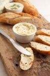 Baguette With Herb Butter And Rosemary Thyme On Rustic Wooden Background Stock Photo