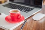 Red Coffee Cup With Notepad And Laptop Stock Photo