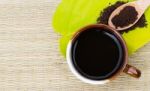Coffee Lover.coffee Cup On Green Leaf With Roasted Coffee On Woo Stock Photo