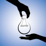 Silhouette Hand Holding Idea Bulb Stock Photo