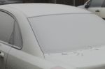 Parked Car Covered With The First Snow In Winter Stock Photo