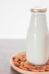 Almond Nuts On Wooden Plate With Milk Stock Photo