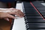 A Woman Playing Piano Stock Photo