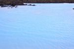 Milky White And Blue Water Between The Lava Stones Covered With Moss Stock Photo