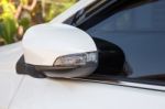 Modern White Car Side View Mirror Folded With Turn Signal Stock Photo