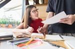 Group Of Hispanic Students Doing Homework Together In The School Stock Photo