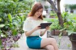 Portrait Of Thai Adult Businesswoman Beautiful Girl Using Her Tablet Stock Photo