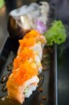 Salmon Sushi Served On Black Plate Stock Photo