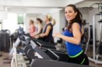 Beautiful Brunette On A Treadmill Stock Photo