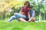 Female Sitting On Man Lap In Green Park  Happy Couple Stock Photo