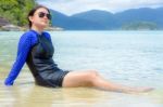 Asian Woman Sitting In The Sea During The Trip To Koh Lipe Island Stock Photo