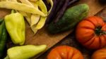 Several Vegetables On Wooden Chopping Board And Table Stock Photo