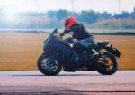 Young Man Riding Motorcycle In Asphalt Road Curve With With A Mo Stock Photo