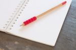 Blank Notebook With Pencil On Grey Background Stock Photo