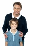 Man In Blue Pullover Posing With His Son Stock Photo