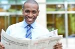 Smiling Executive Holding Newspaper Stock Photo