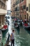 Gondoliers Ferrying Passengers In Venice Stock Photo