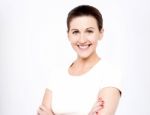 Smiling Women With Arms Crossed Over White Stock Photo