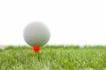 Golf Ball On Plastic Tee In Green Grass Stock Photo