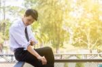 A Young Businessman Is Folding A White Sleeve On His Balcony Stock Photo