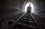 Man In A Tunnel Looking Towards The Light Stock Photo