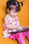 Little Asian Girl Using Digital Tablet, Child Finger Point At Co Stock Photo