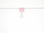 Pink Paperclip Attached On White Paper Isolated Stock Photo