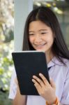 Portrait Of Thai Student Teen Beautiful Girl Using Her Tablet Stock Photo