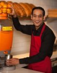 Cheerful Chef Making Fresh Orange Juice Stock Photo