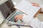 Doctor Hands Typing On Laptop Keyboard Stock Photo