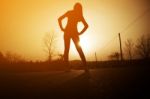 Woman Exercising Outdoor At Sunset  Stock Photo