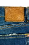 Blue Jeans With Leather Label On White Stock Photo