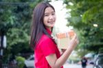 Portrait Of Thai Teen Beautiful Girl In Chinese Dress, Happy New Year And Open Box Gift, Smile And Very Happy Stock Photo