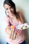 Cute Young Woman Eating Jelly Candies With A Fresh Smile Stock Photo