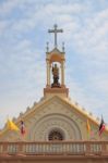 Statue Of Priest On The Gable Top Of Roof Church Stock Photo