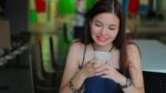 Portrait Of Thai Adult Beautiful Girl Using Her Smart Phone And Smile Stock Photo